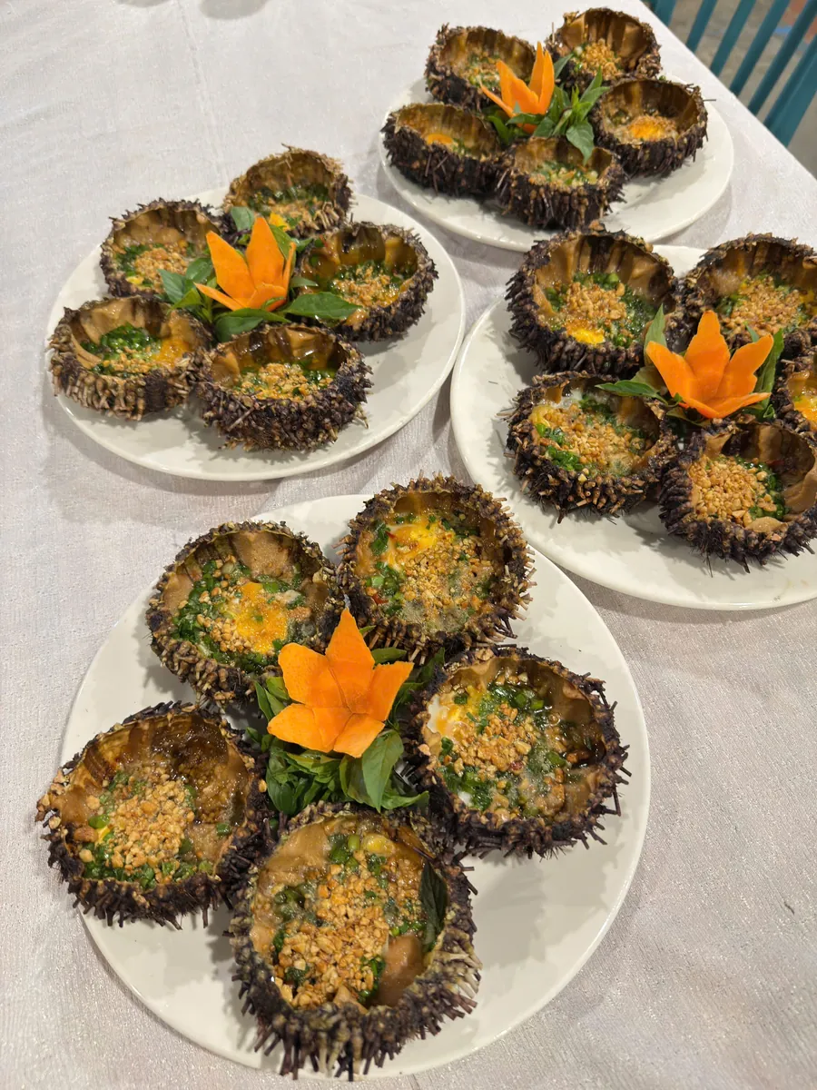 Plates of sea urchins grilled with scallion oil and roasted peanuts