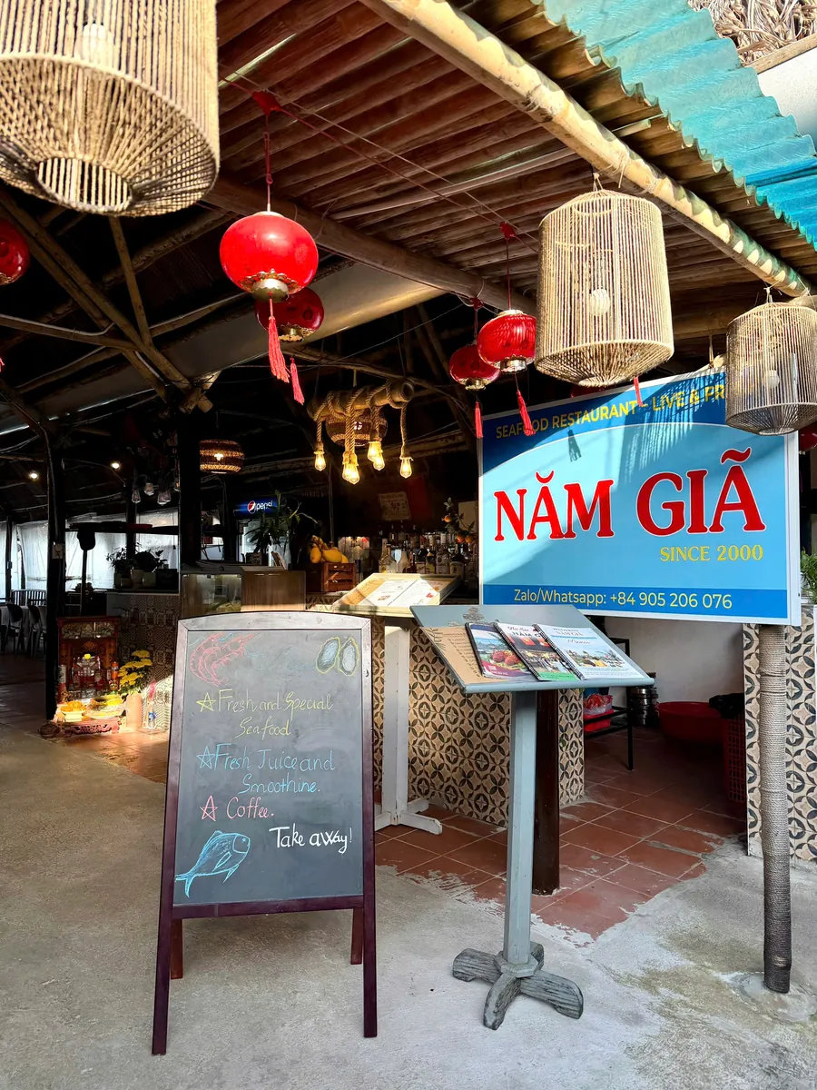 Blue Năm Giã sign at the entrance of Nam Gia Seafood Restaurant, An Bang Beach