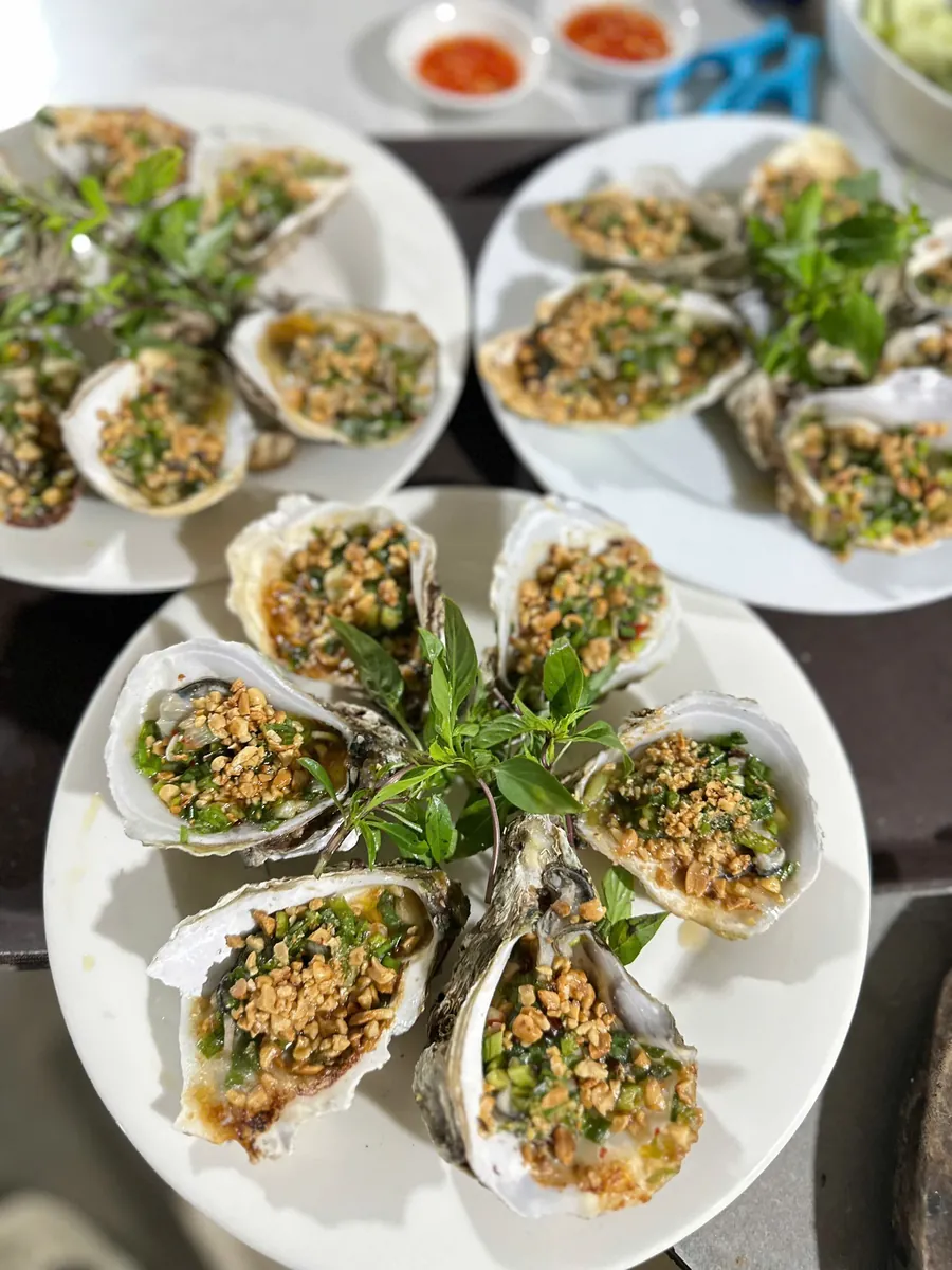 Oysters grilled with scallion oil and roasted peanuts